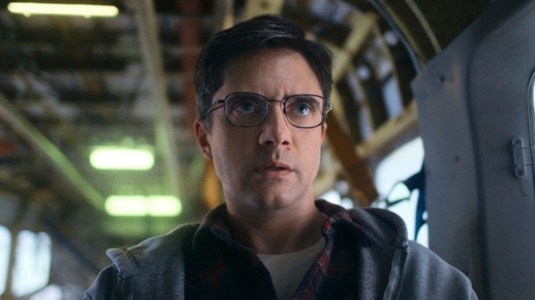 Topher Grace as Winston looking towards the cockpit with concern in Flight Risk