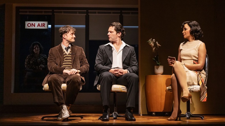 Merrily We Roll Along's Charley (Daniel Radcliffe) glancing at Franklin (Jonathan Groff) at a TV interview