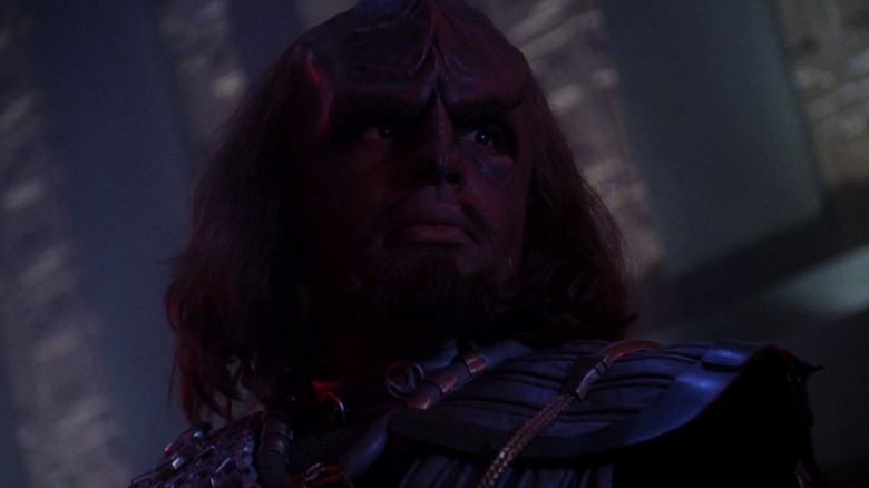 A low shot of Worf, in his Klingon uniform, looking dramatic.