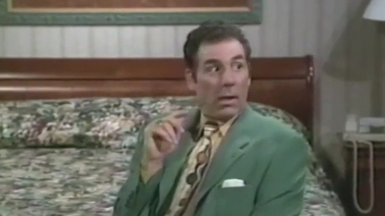 VIC nardoza in a green suit in a motel room in Michael Richards show.