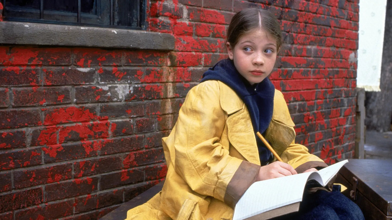 Harriet writing in her notebook in Harriet the Spy