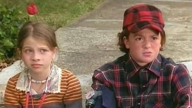 Nona and Little Pete sitting on the sidewalk on The Adventures of Pete & Pete