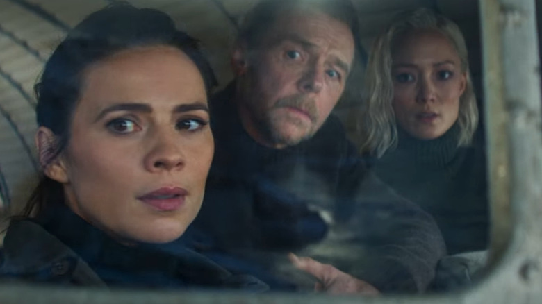 Grace (Hayley Atwell), Benji (Simon Pegg), and Paris (Pom Klementieff) staring out window in "Mission: Impossible – The Final Reckoning."