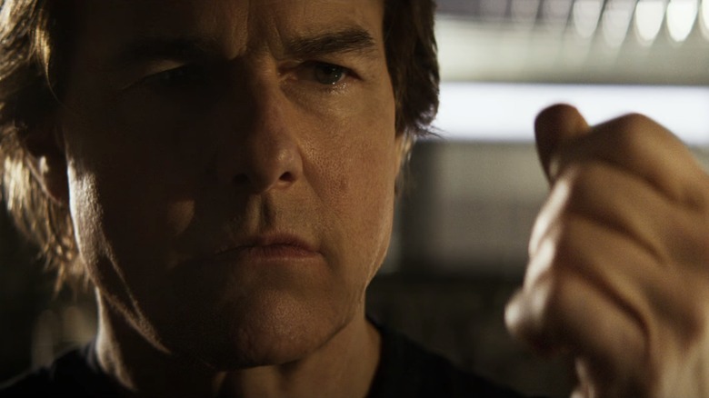 Ethan Hunt (Tom Cruise) looks at his hand in Mission: Impossible – The Final Reckoning