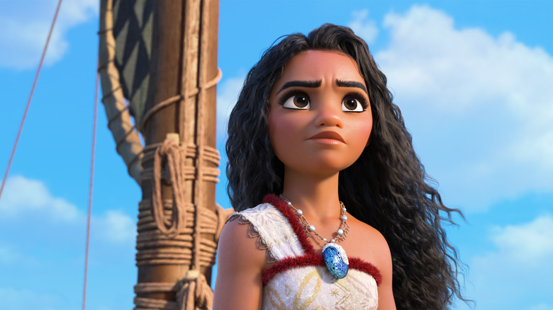 Moana standing atop a boat on the ocean in Moana 2