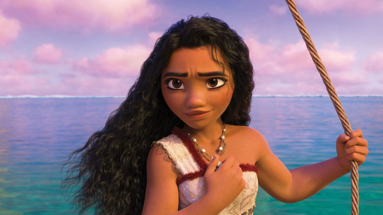 Moana holds her necklace in Moana 2