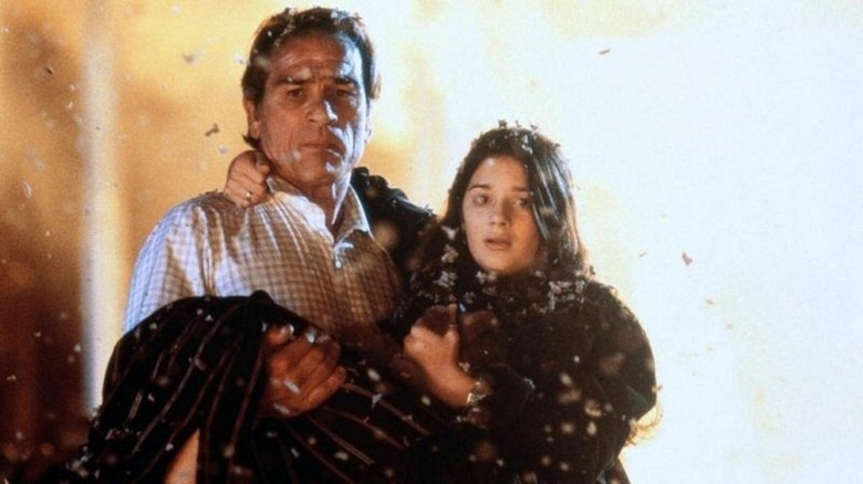 Mike carries his daughter Kelly through some ash in Volcano