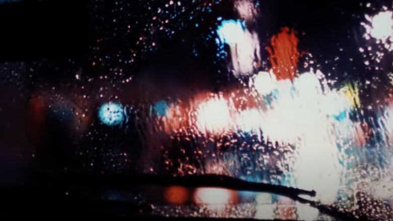 Taxi Driver opening neon lights rain car windshield