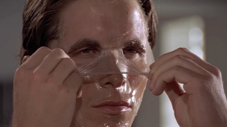 Patrick Bateman peels a face mask away