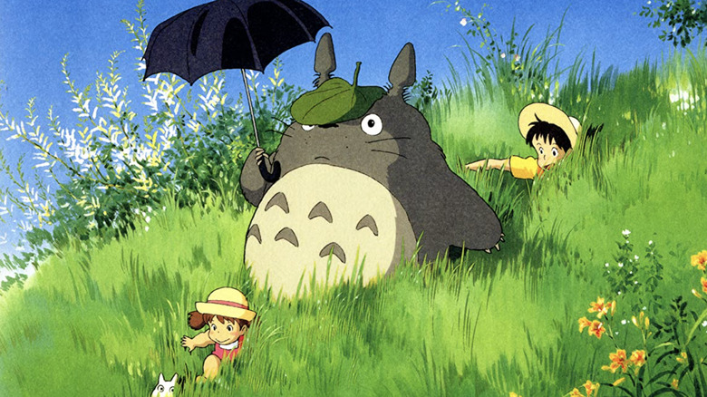 Satsuki, Mei and Totoro playing in the grass