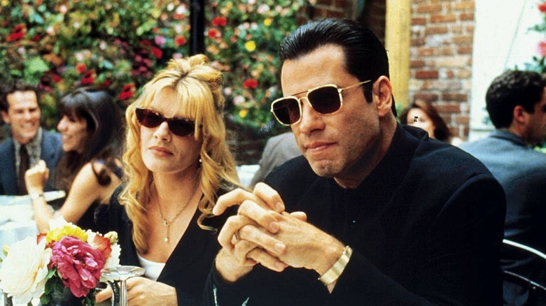 John Travolta and Rene Russo in sunglasses