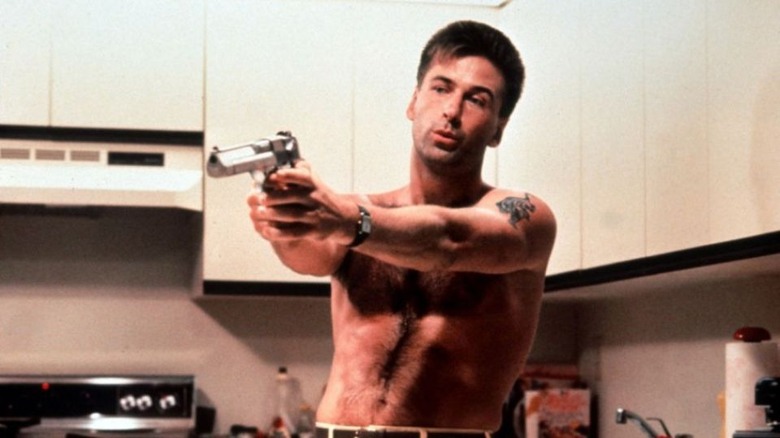 Shirtless Alec Baldwin points gun