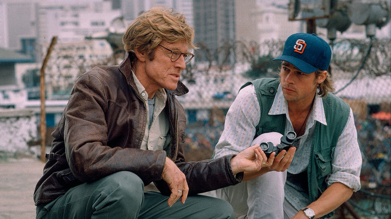 Robert Redford and Brad Pitt look through binoculars