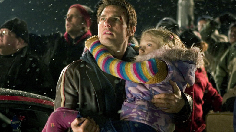 Tom Cruise carries Dakota Fanning