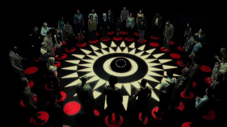 People stand around a circle