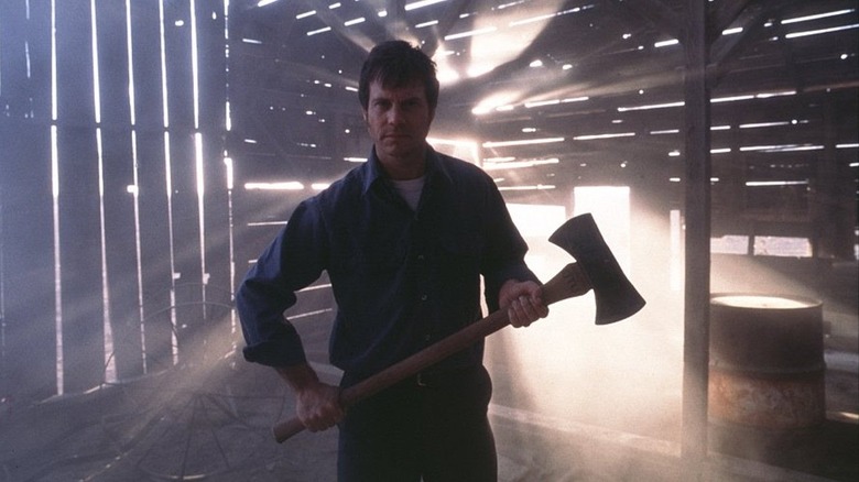 frailty bill paxton holds axe in a barn