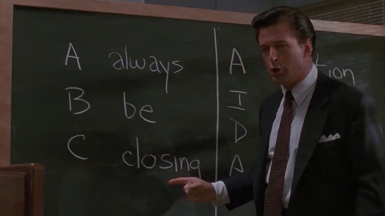 Alec Baldwin yelling next to chalkboard