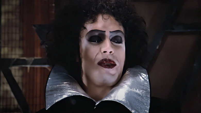 Tim Curry as Dr. Frank-N-Furter smiles in The Rocky Horror Picture Show