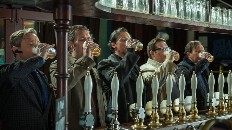 The lads chug pints of beer together