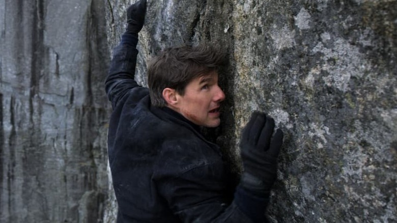 Ethan Hunt climbing a rock wall