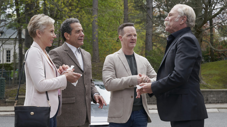 Natalie, Monk, Randy, and Leland stand in a driveway