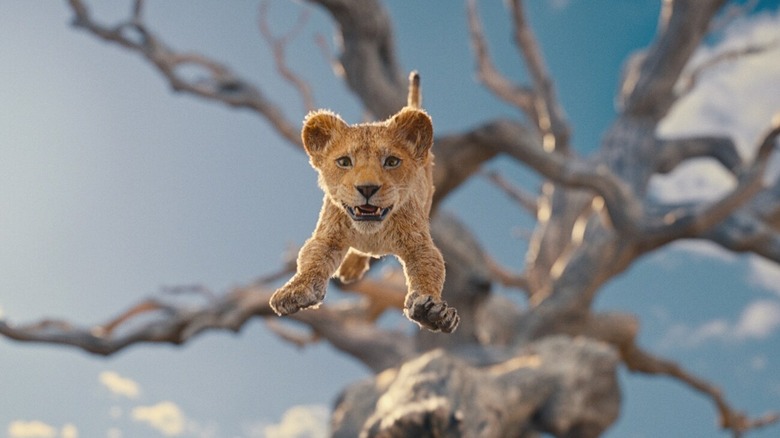 Baby Mufasa leaping off of a tree in Mufasa: The Lion King