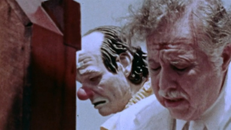 Lincoln Maazel and a clown, both looking down