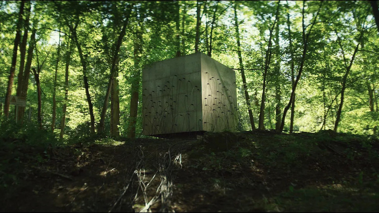 A cube sits in the forest in Lapsis 