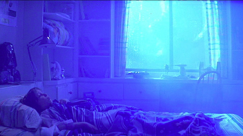 Oliver Robbins lies in bed as his room fills up with light in Poltergeist