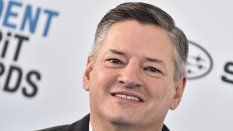 man smiling at camera with dark and grey hair