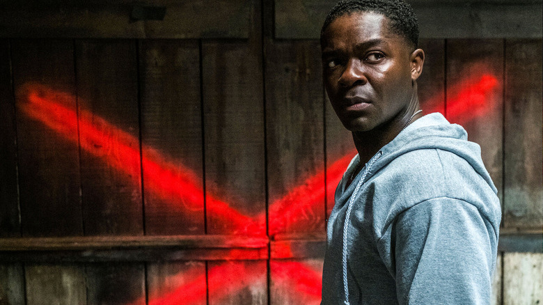 David Oyelowo's Jack standing in front of a spray painted red X in Don't Let Go