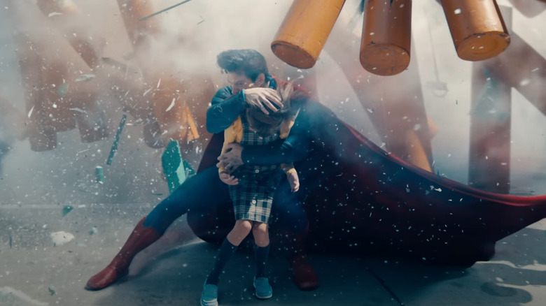 David Corenswet's Superman saving a little girl from debris in Superman (2025)