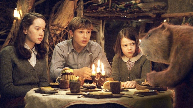 Susan, Peter, and Lucy look at Mr. Beaver over a table in The Chronicles of Narnia: The Lion, the Witch and the Wardrobe