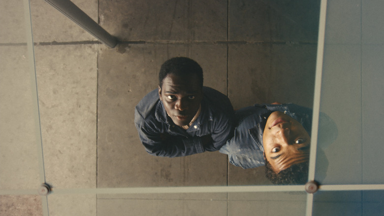 Elwood and Turner look at their reflections in a mirrored ceiling in Nickel Boys