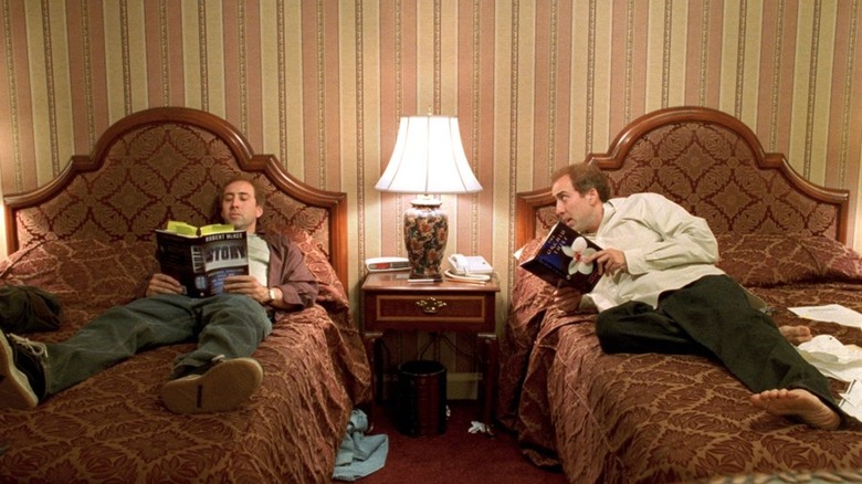 Nicolas Cage sitting on two beds as Charlie and Donald Kaufman in Adaptation