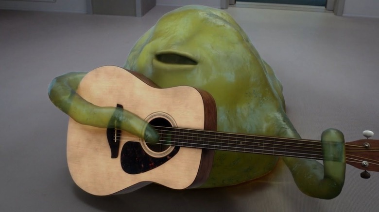 Norm Macdonald as Yaphit holding guitar The Orville
