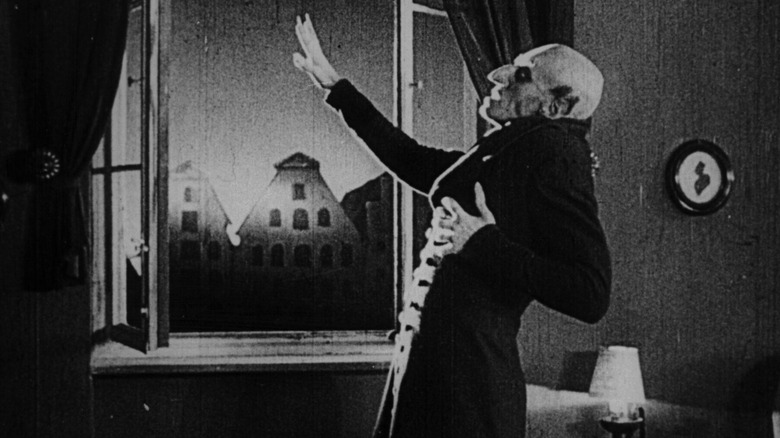 Count Orlok tries to stop the sun in Nosferatu 1922