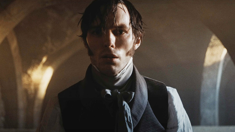 Nicholas Hoult's Thomas Hutter looks scared as he walks through a castle in Nosferatu