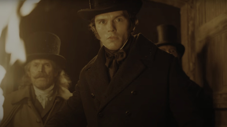 Nicholas Hoult's Thomas Hutter stands beside Willem Dafoe's Prof. Albin Eberhart Von Franz in Nosferatu