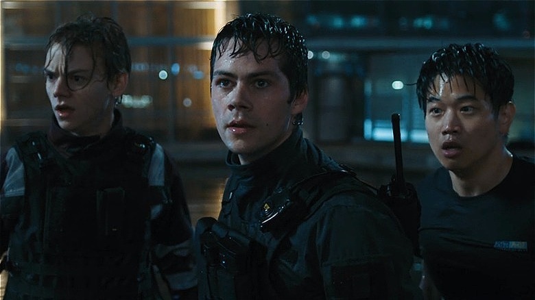 Thomas Brodie-Sangster, Dylan O'Brien, and Ki Hong Lee in tactical outfits in the rain