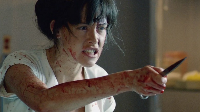 Bloody Paz de la Huerta holding scissors