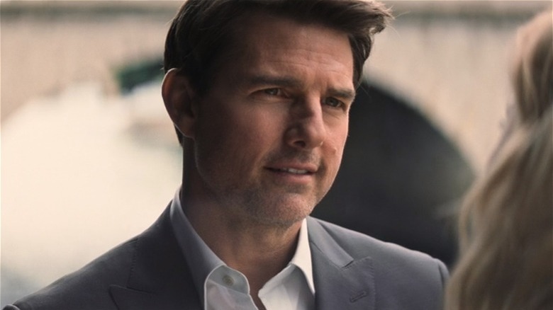 Tom Cruise smiling faintly grey suit Mission Impossible Fallout