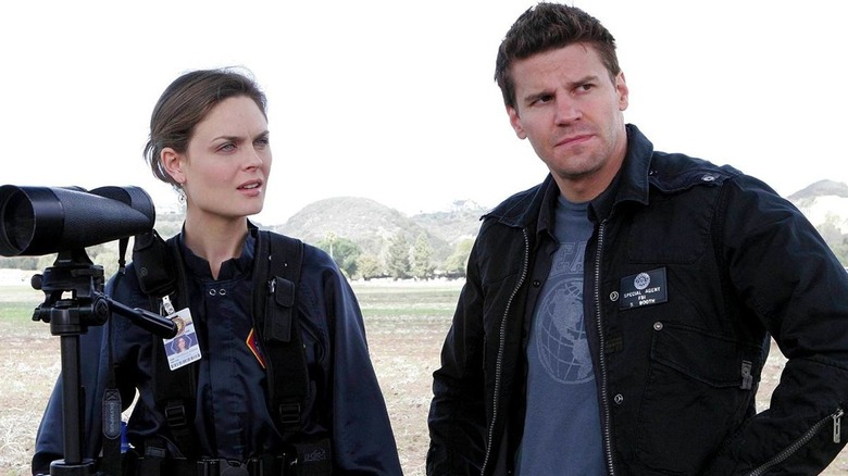 Temperance "Bones" Brennan and Seeley Booth at a crime scene looking concerned in Bones