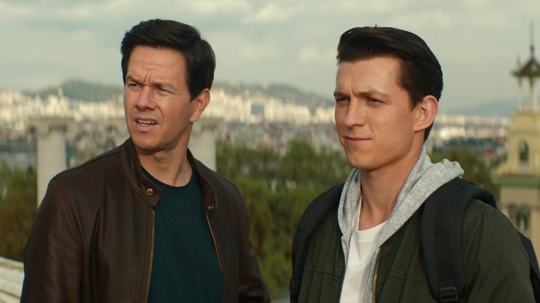 Mark Wahlberg and Tom Holland looking off-screen in Uncharted