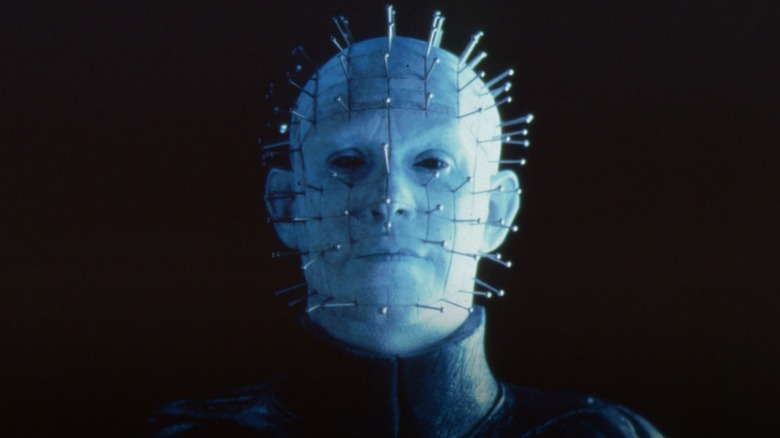 Pinhead smiling in a dark room in Hellraiser: Inferno