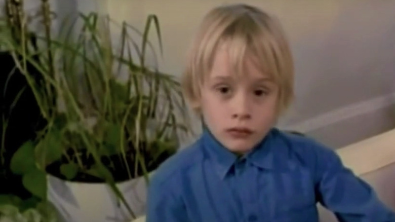 MaCaulay Culkin's Paul Gephardt looks up at the camera wearing a blue shirt in The Equalizer