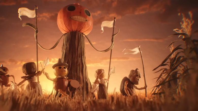 A group of people wearing pumpkin costumes dancing in Over the Garden Wall