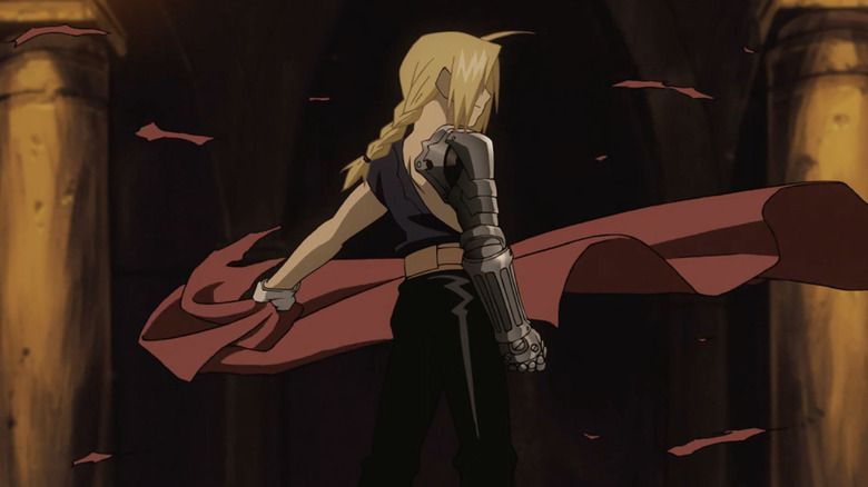 Edward Elric tears off his red coat and reveals his robotic automail arm in Fullmetal Alchemist: Brotherhood