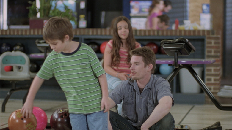 Ellar Coltrane's Mason Evans Jr. grabs a bowling ball while Ethan Hawke's Mason Evans Sr. sits and talks to him in Boyhood