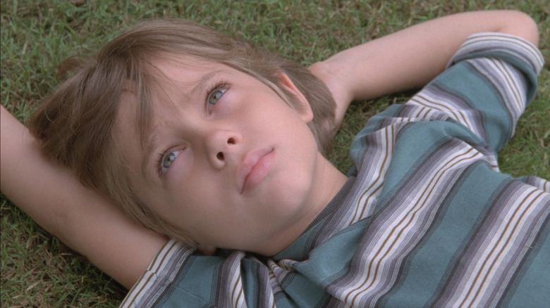 Mason Evans Evans Evans Evans lies in the grass looking at the sky in the boy